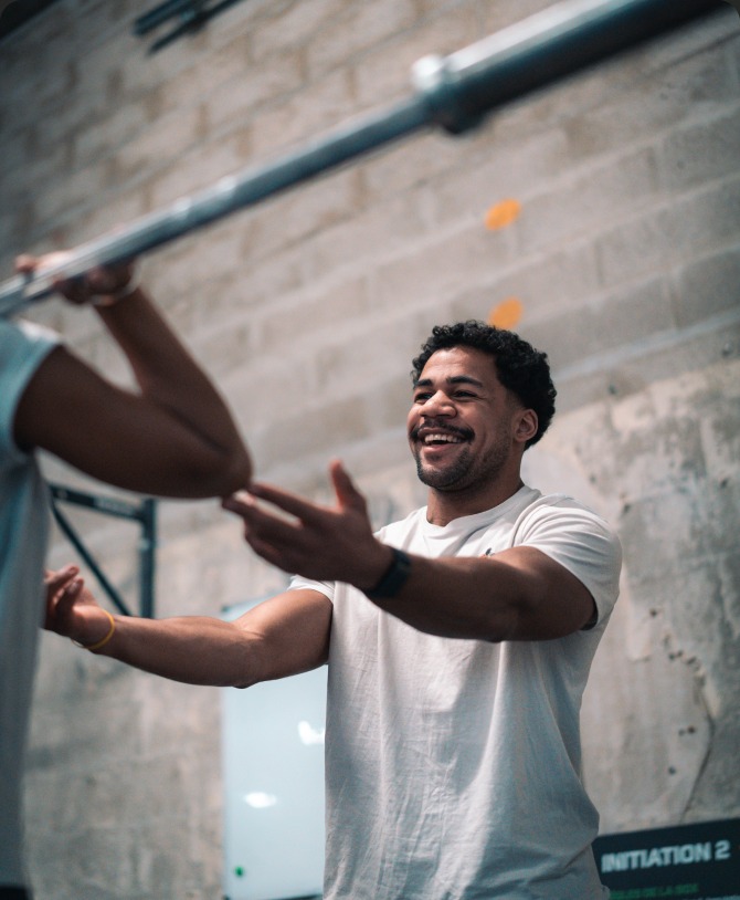Un coach encourage un athlète à la barre de traction